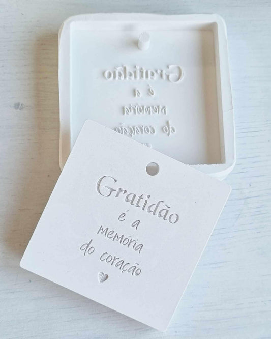 Molde branco com frase “Gratidão é memória do coração” em relevo