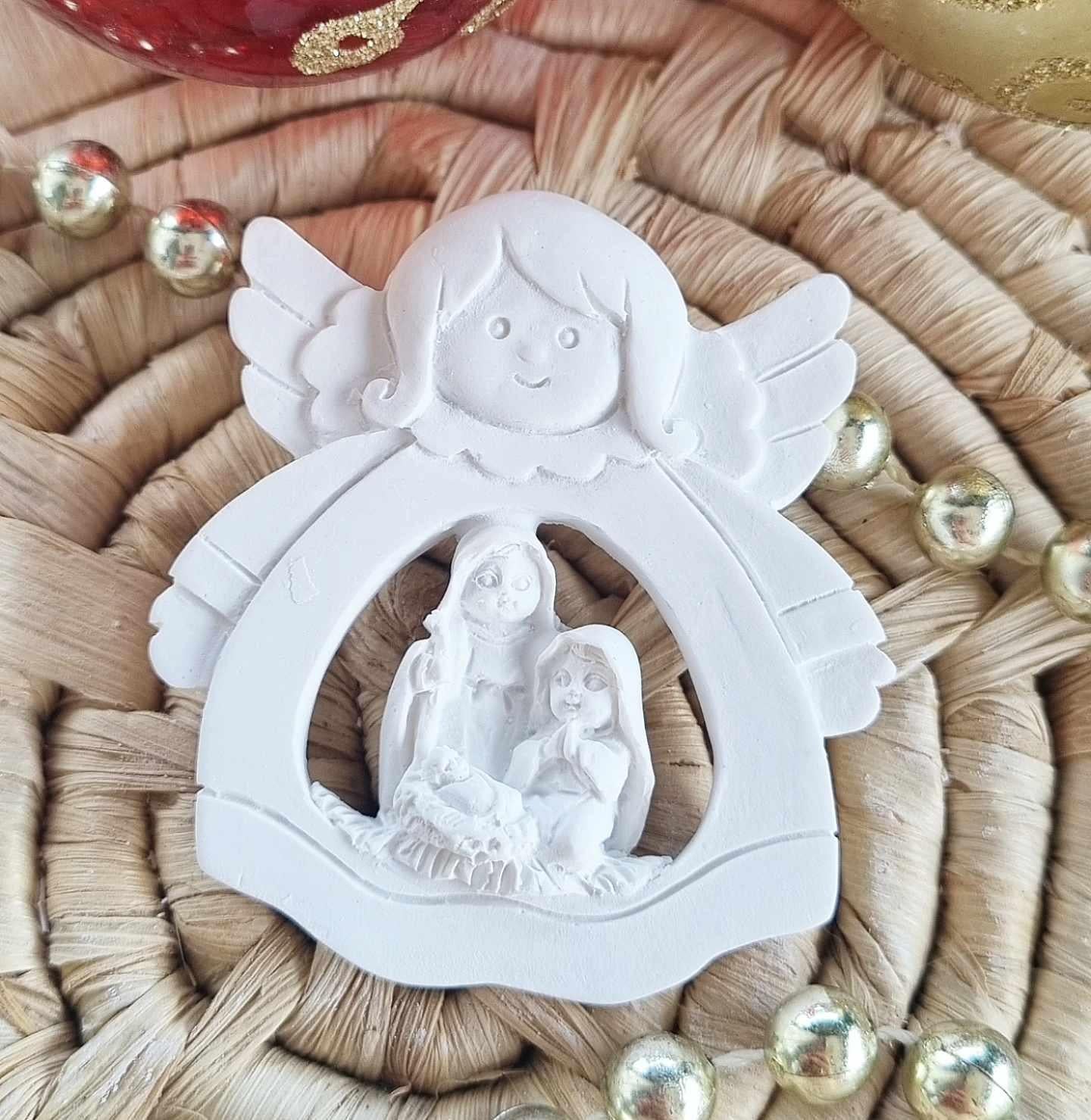 Molde de anjo branco com presépio em aro circular, figuras em relevo