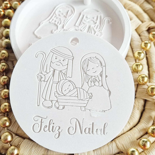 Molde redondo branco com presépio em relevo e furo; texto “Feliz Natal”