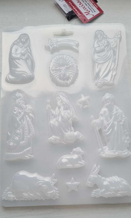 Molde em PVC flexível para presépio, com figuras em relevo e estrelas.