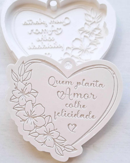 Molde de coração com flores em relevo e frase 'Quem planta amor, colhe felicidade'