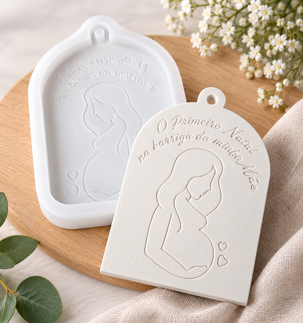 Molde de silicone branco com contorno de grávida e bebé e texto «O Primeiro Natal»