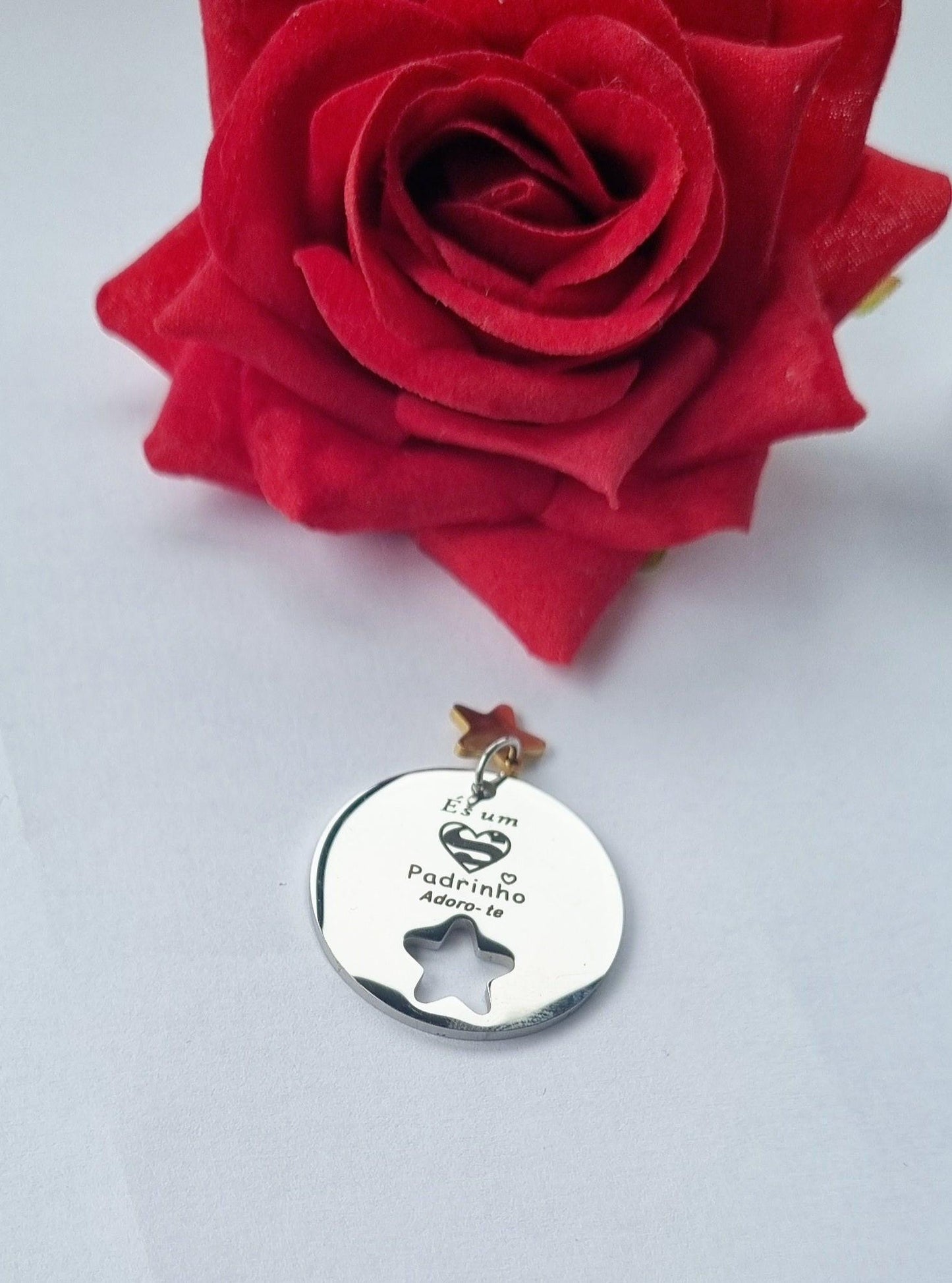 Medalha prateada redonda com estrela recortada e inscrição Padrinho.