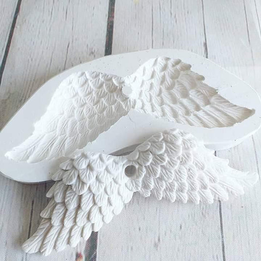 Molde de asas de anjo branco, com relevo de penas e base oval