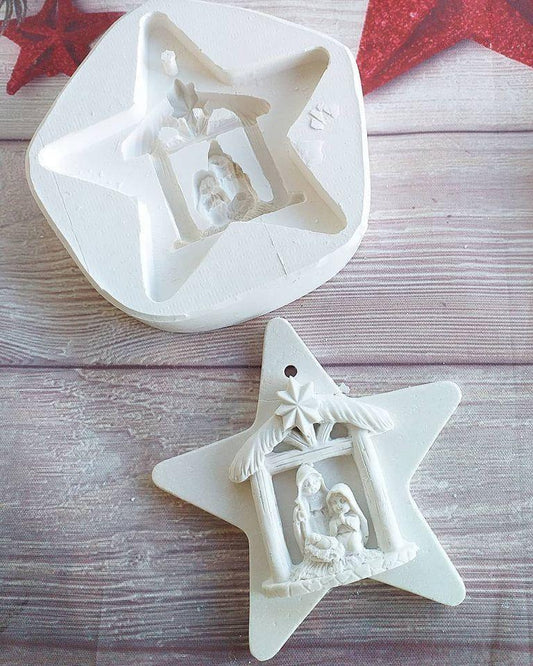 Molde de estrela para presépio com relevo de figuras e manjedoura
