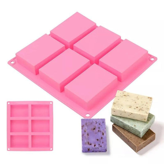Molde rosa de silicone com 6 compartimentos retangulares e furos de fixação