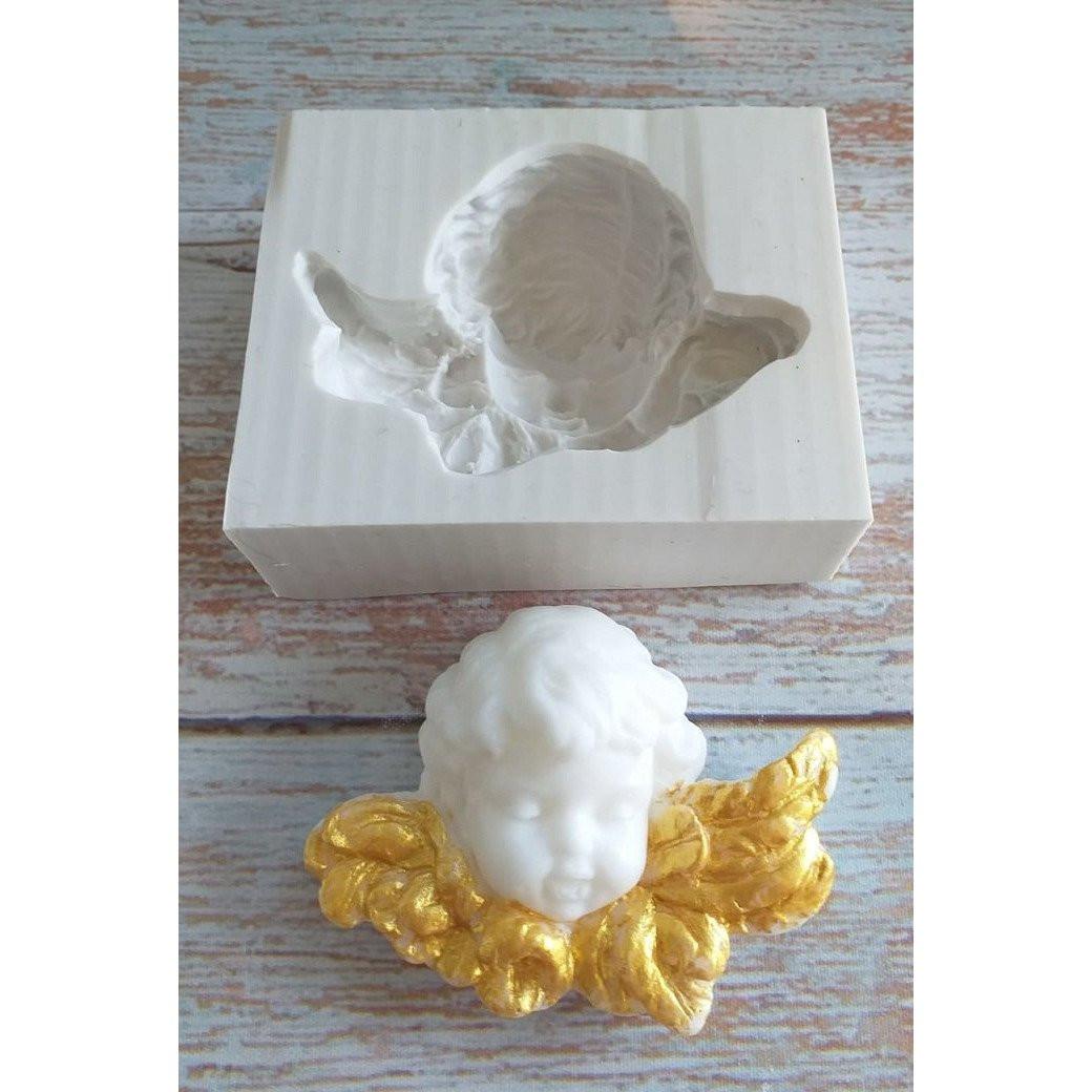 Molde de silicone com cabeça de anjo em relevo, com asas douradas