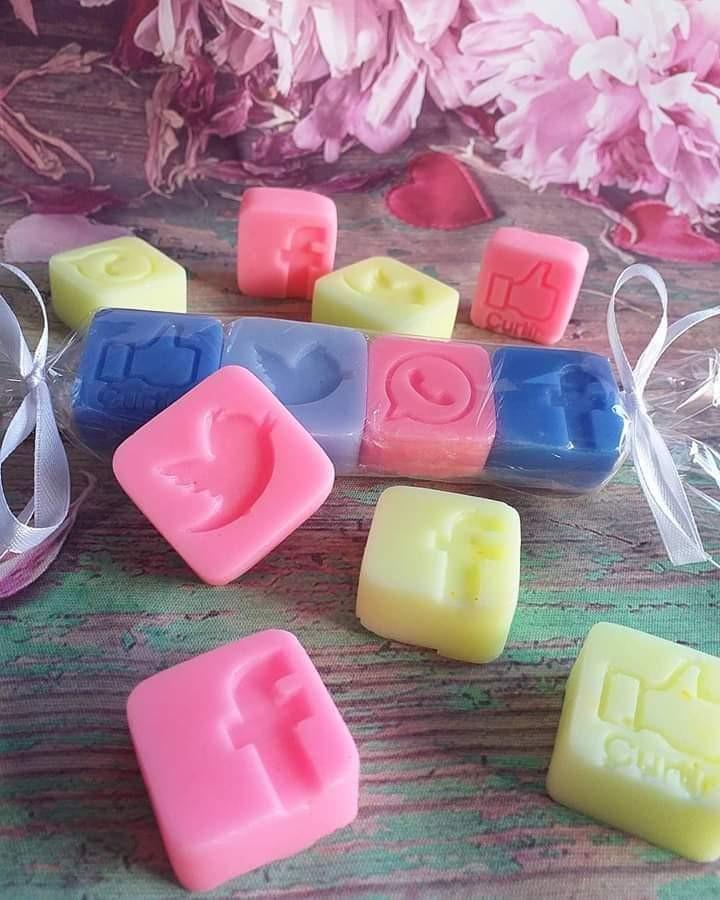 sabonetes quadrados com relevo rosa, azul e amarelo, com formas decorativas