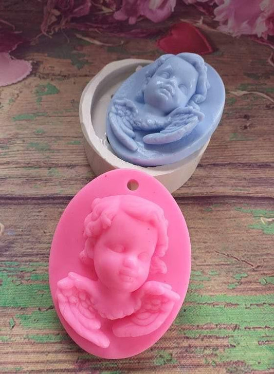 Dois moldes ovais para anjo-bebé, azul e rosa, com relevo de bebé deitado