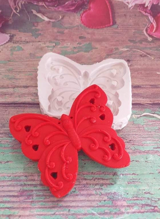 Molde de borboleta em silicone branco com peça de borboleta vermelha