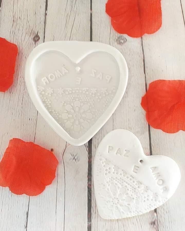 Dois moldes de coração brancos com textura rendada e inscrição 'PAZ'