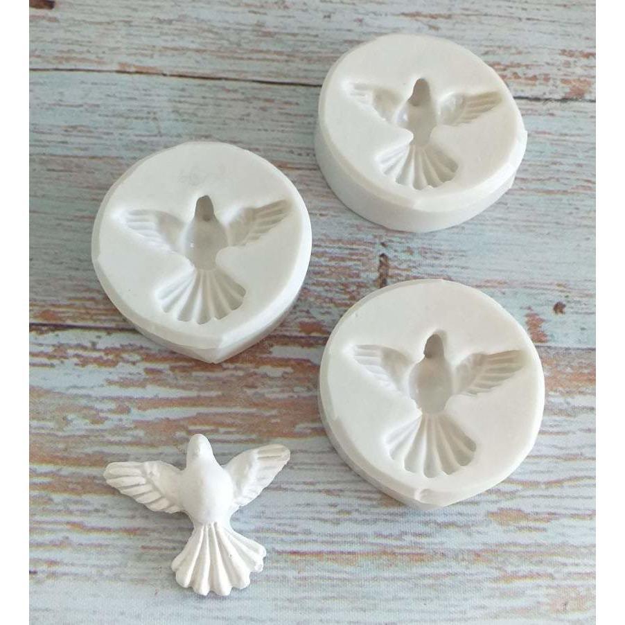 Molde de pomba: moldes redondos com relevo de pomba e peça decorativa branca